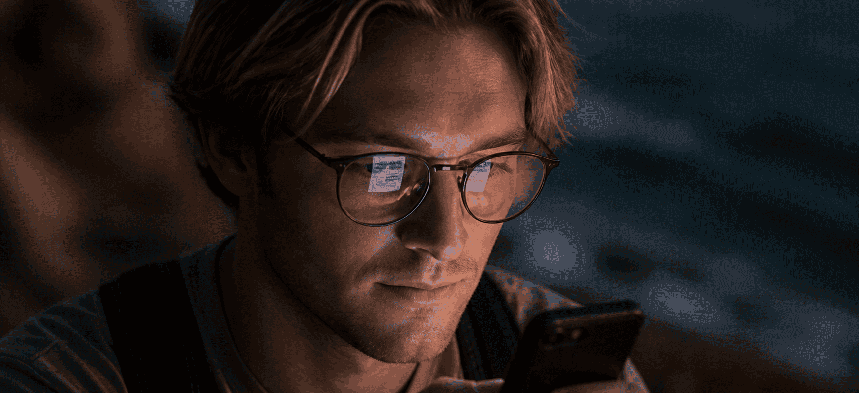 A man reading his phone at dusk, from the Keyphone film
