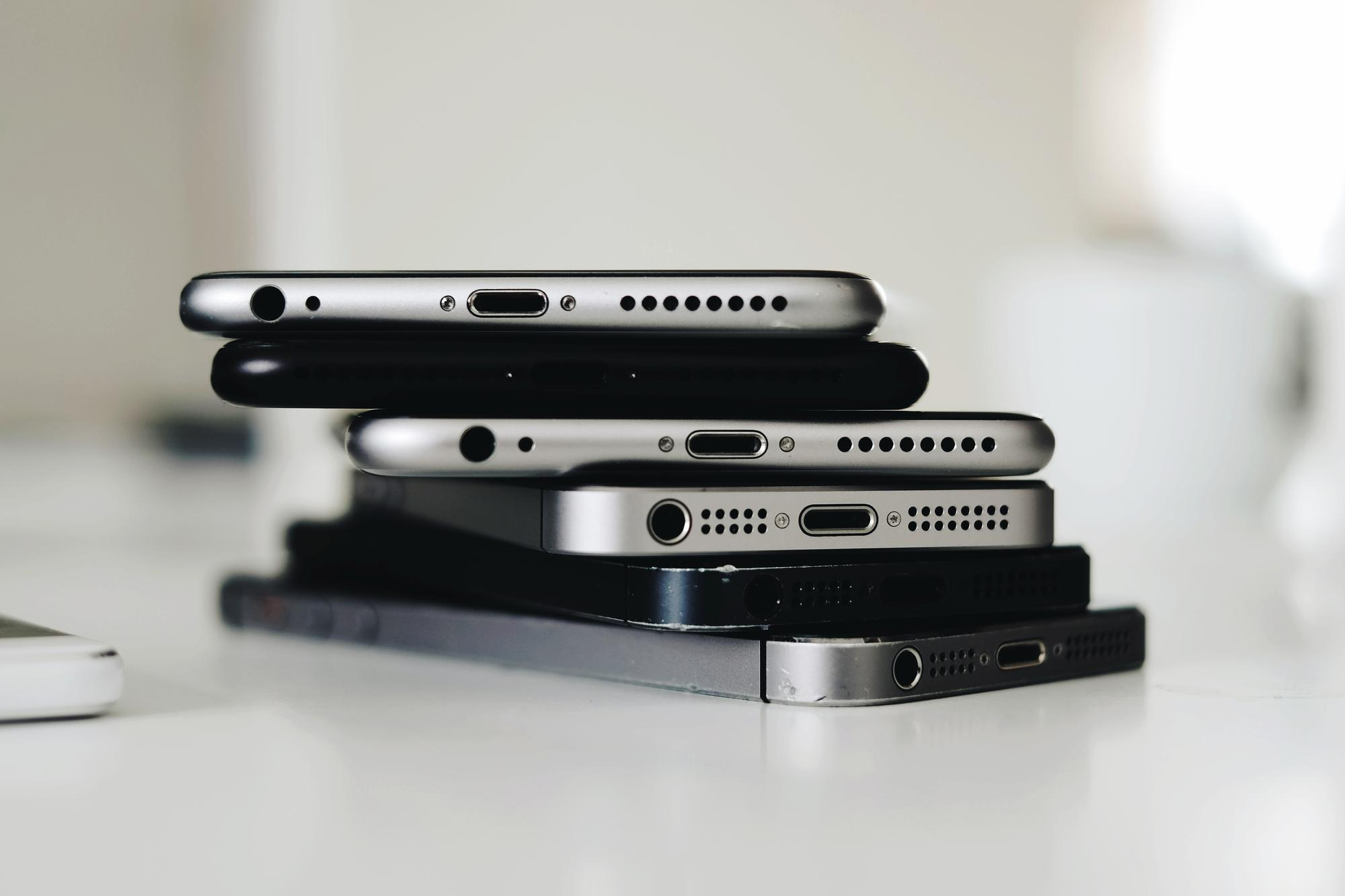 Friends having a phone-free dinner by stacking their phones on the table